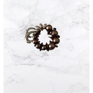 Vintage brooch with bronze pearls on silver tone background m